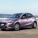 2014 Mazda DJ Mazda2 Maxx: Smoky Rose Mica front quarter on beach