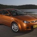 2007 Proton BS Satria Neo: orange front quarter by lake